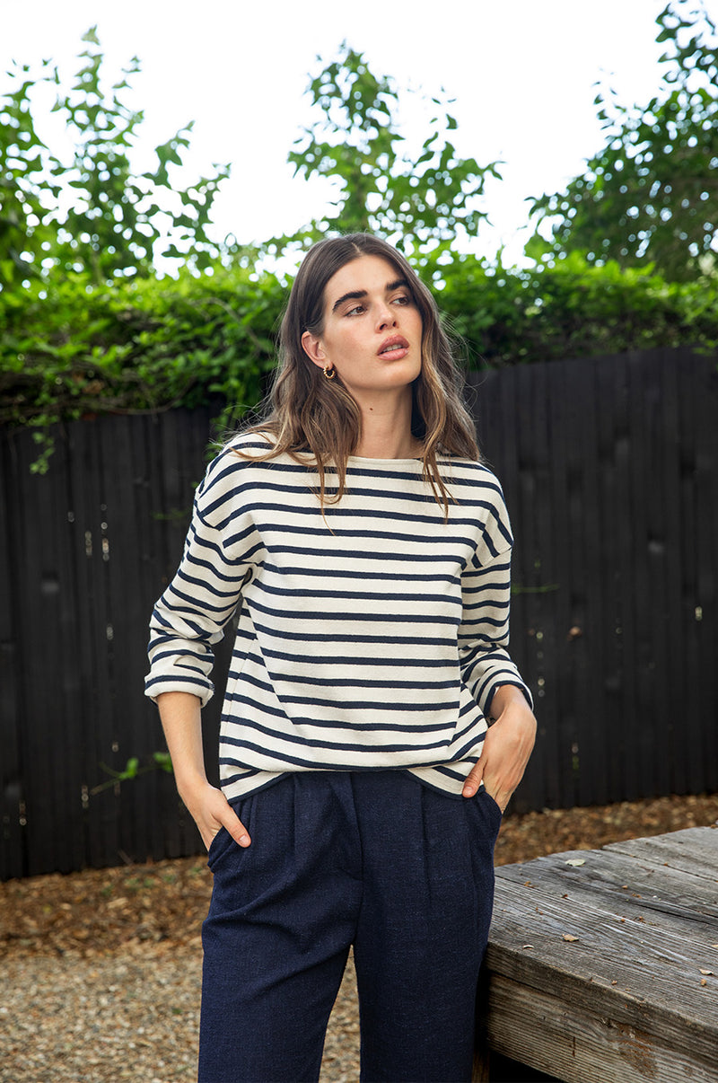 Brunette model wearing the lady & the sailor Boxy Pullover in Navy Stripe.