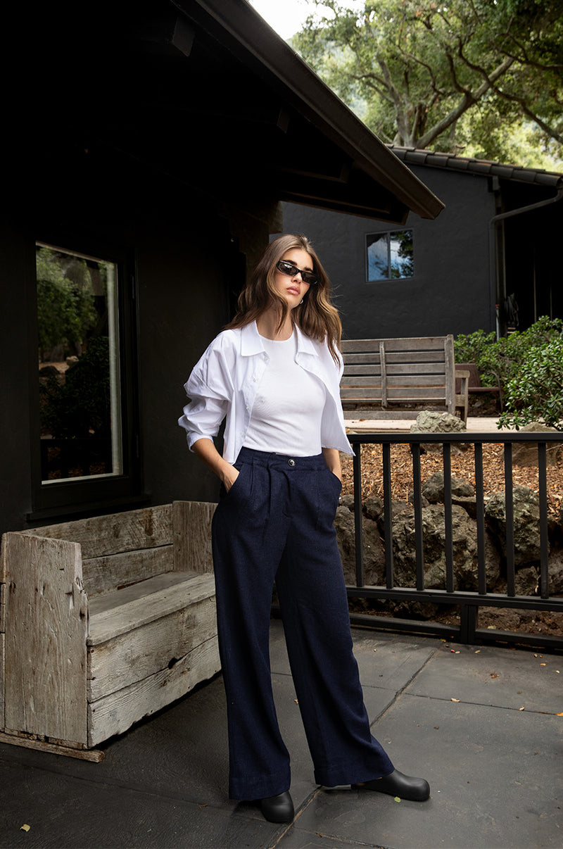 Brunette model wearing the lady & the sailor Slouchy High Waisted Trouser in Midnight.