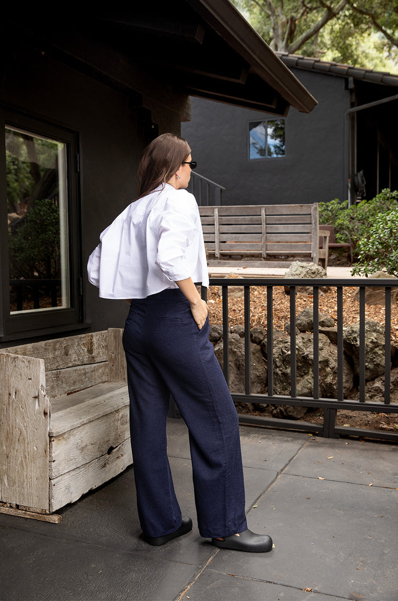 Brunette model wearing the lady & the sailor Slouchy High Waisted Trouser in Midnight.