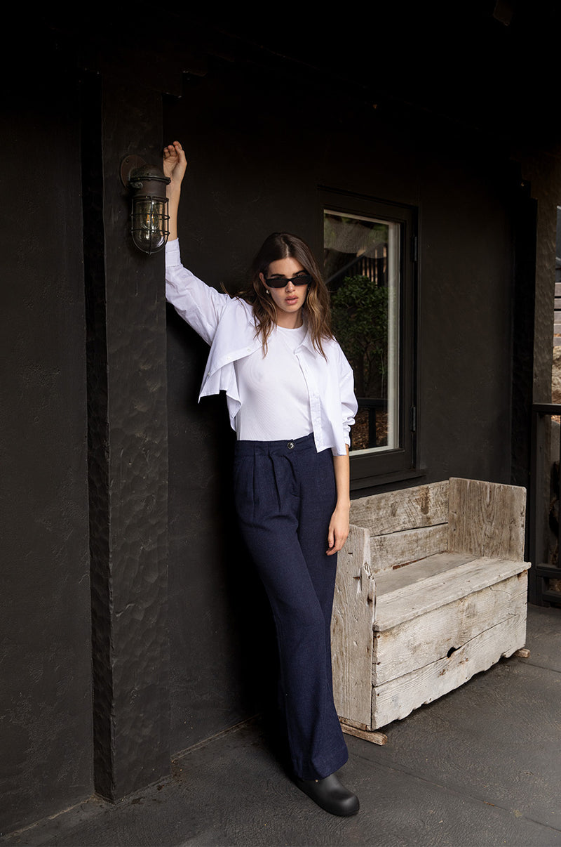 Brunette model wearing the lady & the sailor Slouchy High Waisted Trouser in Midnight.