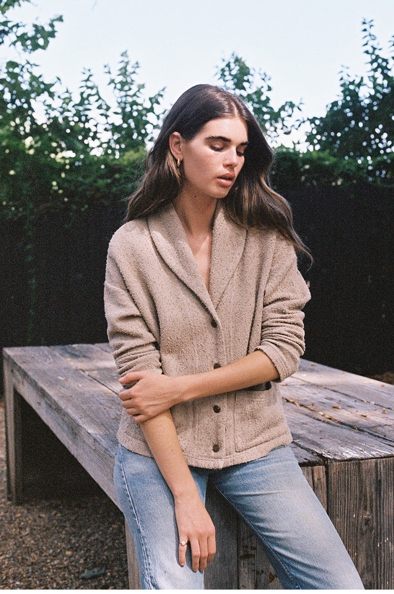 Brunette model wearing the lady and the sailor Pocket Cardi in Stone Bouclé.