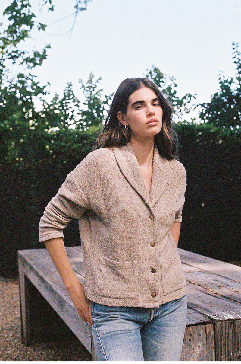 Brunette model wearing the lady and the sailor Pocket Cardi in Stone Bouclé.