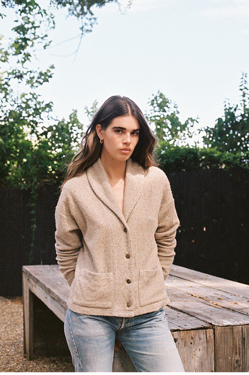 Brunette model wearing the lady and the sailor Pocket Cardi in Stone Bouclé.