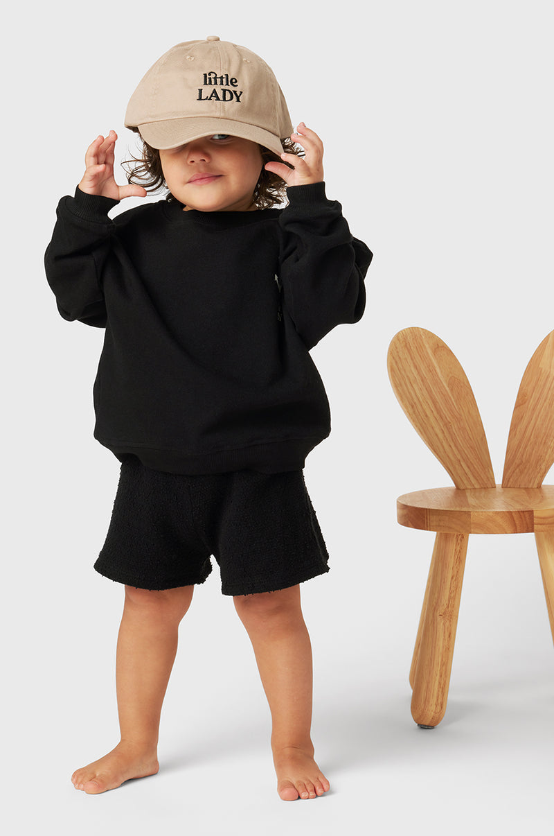 Model wearing Kids Weekend Short in Black Bouclé little lady & petit sailor
