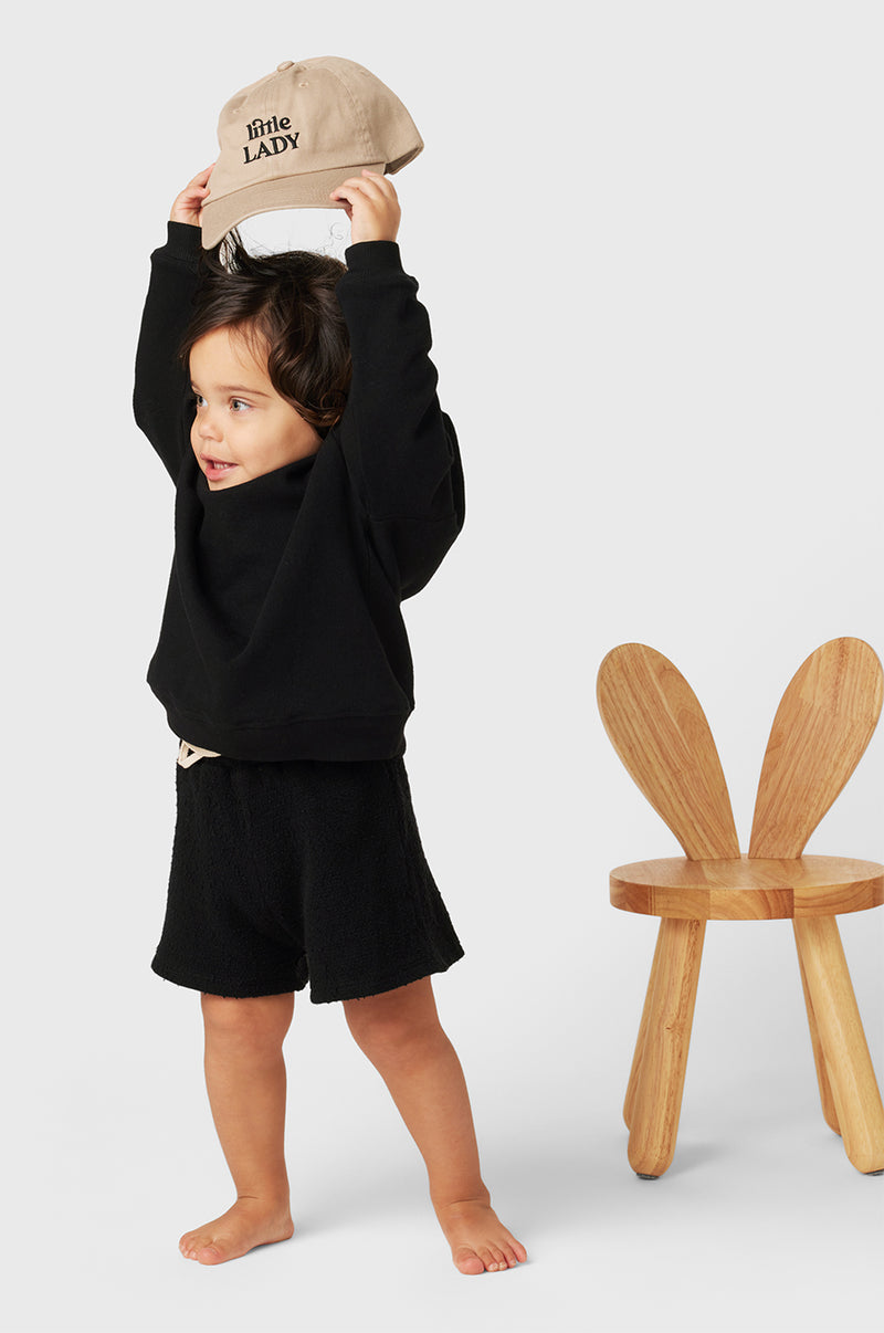 Model wearing Kids Weekend Short in Black Bouclé little lady & petit sailor
