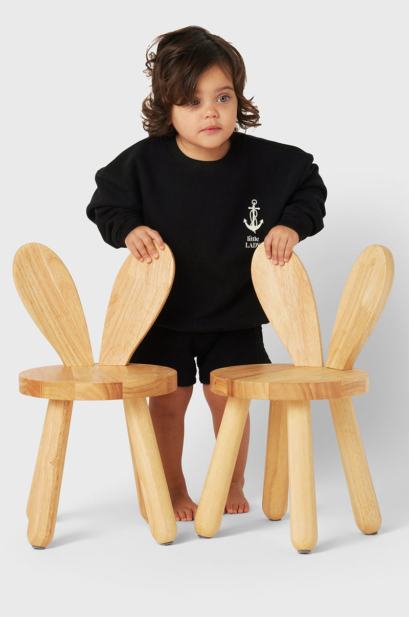 Model wearing Little Lady Varsity Crewneck in Black Organic Cotton little lady & petit sailor