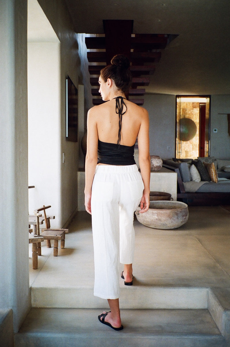 Model wearing the lady & the sailor Wrap Halter Top in black linen.
