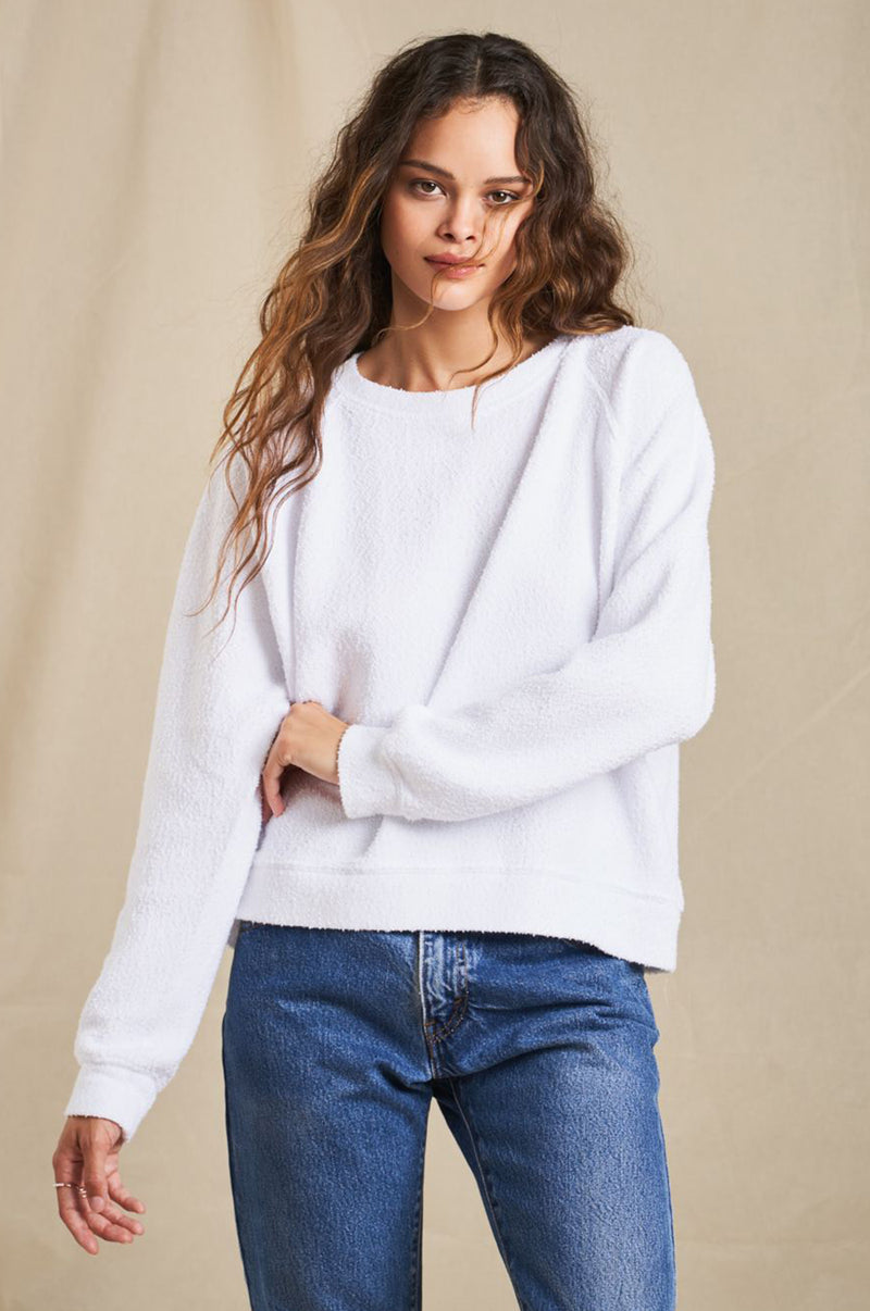 Brunette Model wearing the lady & the sailor Brentwood Sweatshirt in White Bouclé.