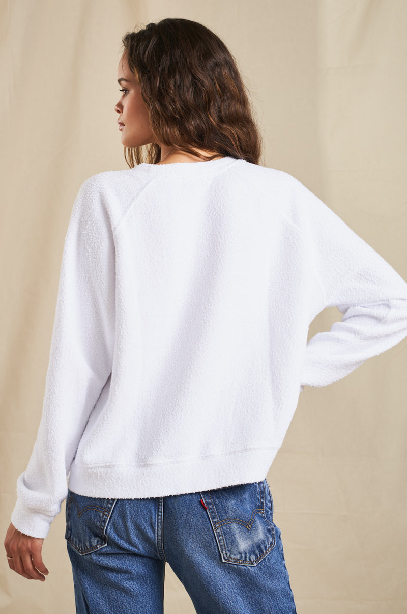 Brunette Model wearing the lady & the sailor Brentwood Sweatshirt in White Bouclé.