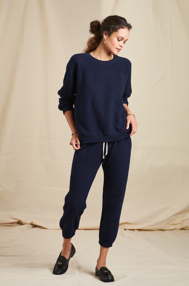 Brunette Model wearing the lady & the sailor Brentwood Sweatshirt in Navy Boucle.