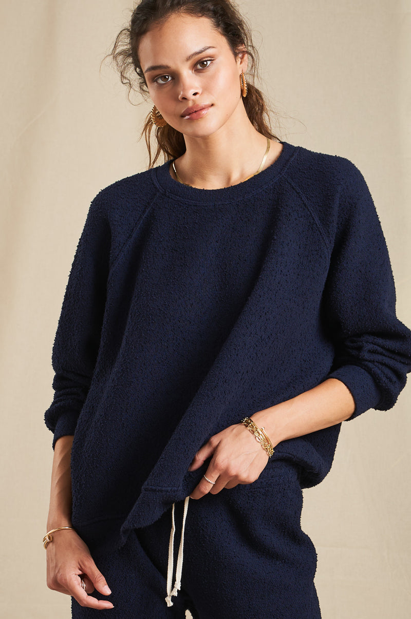 Brunette Model wearing the lady & the sailor Brentwood Sweatshirt in Navy Boucle.