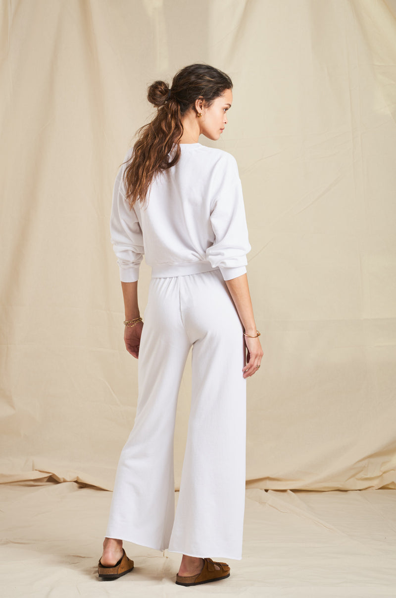 Model wearing the lady & the sailor French Flare Pant in White Organic Cotton.