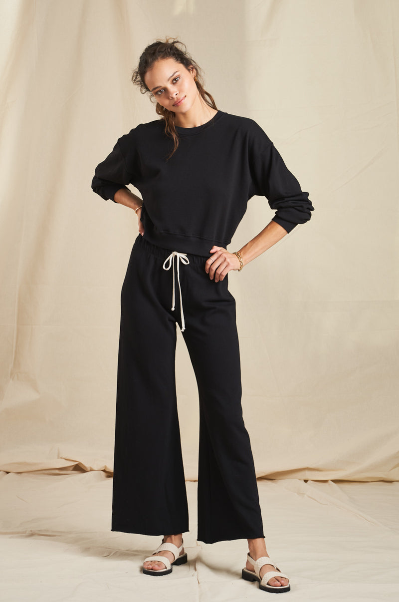 Model wearing the lady & the sailor French Flare Pant in Black Organic Cotton.