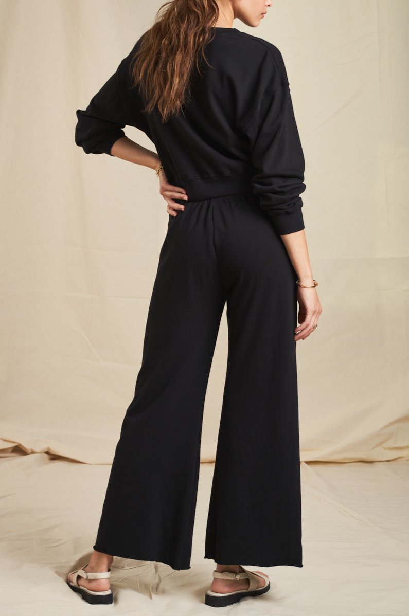 Model wearing the lady & the sailor French Flare Pant in Black Organic Cotton.