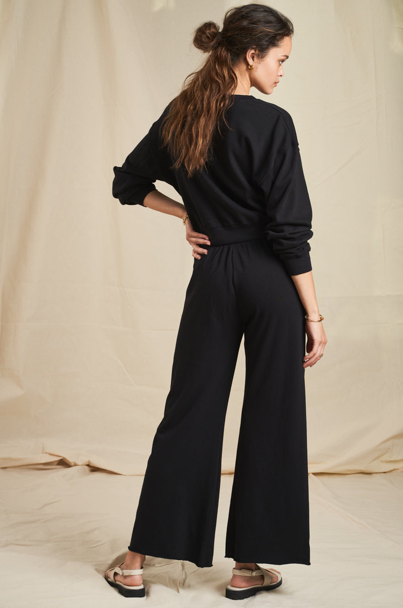 Model wearing the lady & the sailor French Flare Pant in Black Organic Cotton.