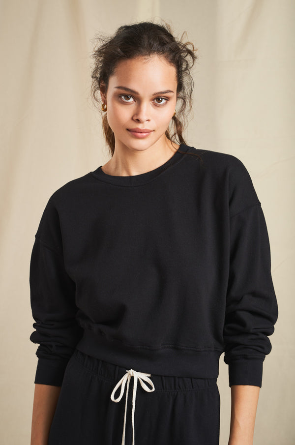 Model wearing the lady & the sailor Cropped Sweatshirt in Black Organic Cotton 