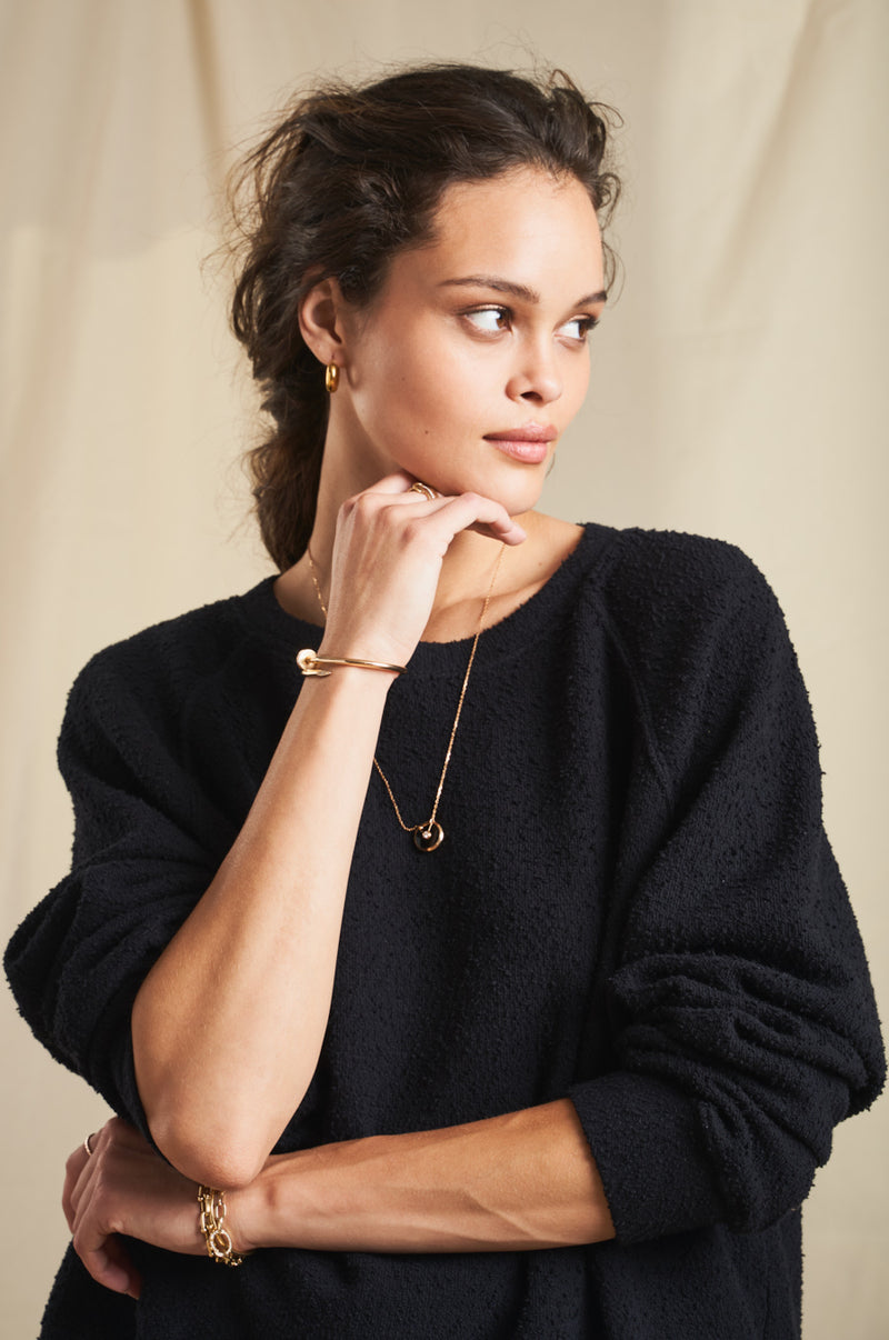 Model wearing the lady & the sailor Brentwood Sweatshirt in Black Boucle.