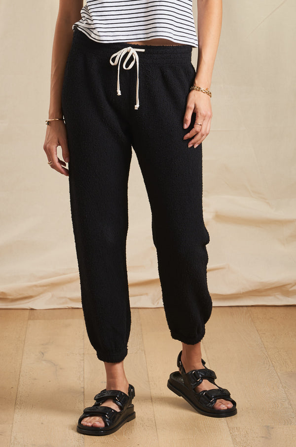 Model wearing the lady & the sailor Vintage Sweatpant in Black Boucle.