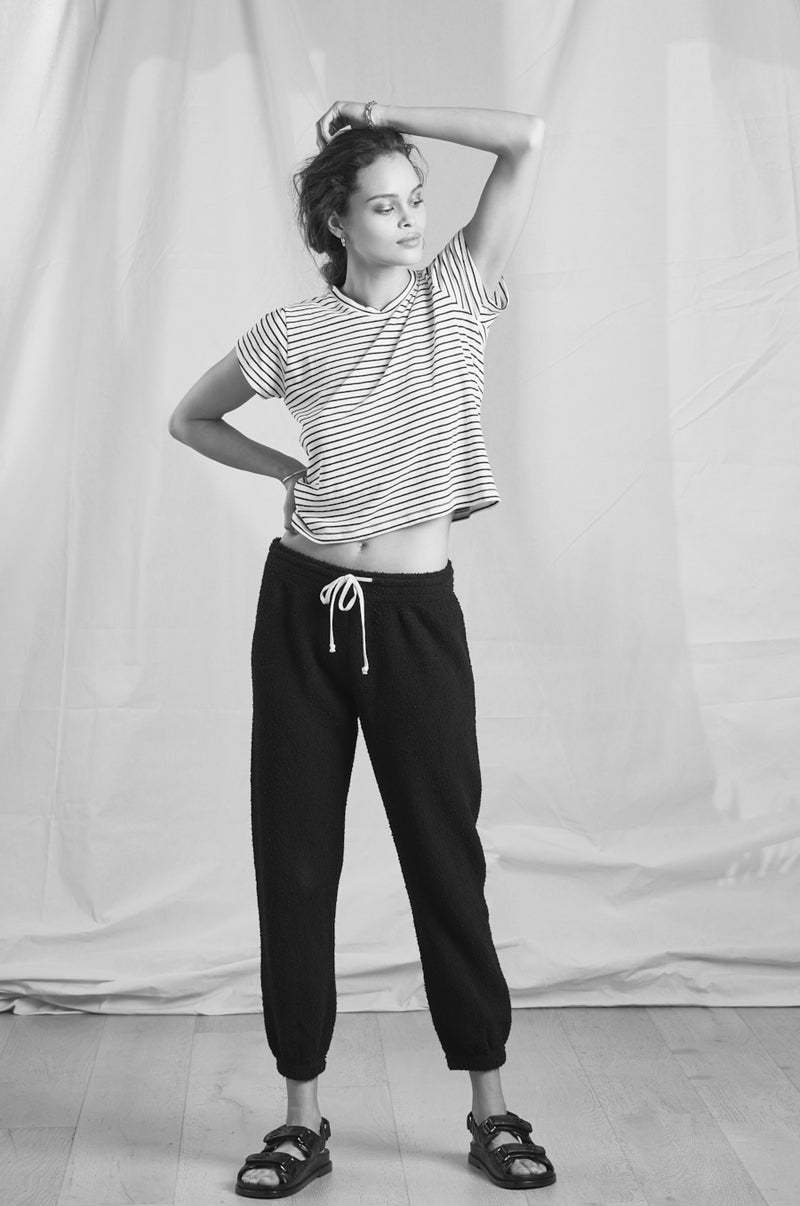 Model wearing the lady & the sailor Vintage Sweatpant in Black Boucle.
