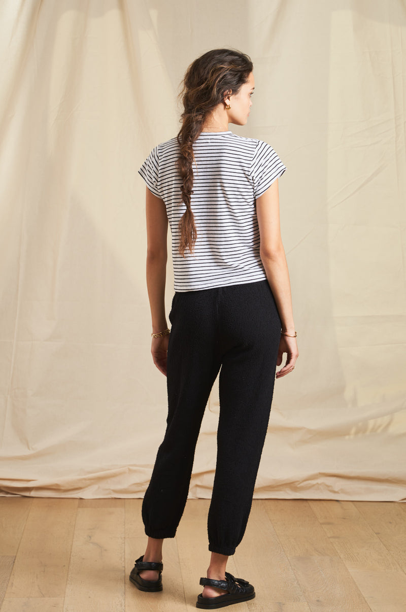 Model wearing the lady & the sailor Vintage Sweatpant in Black Boucle.
