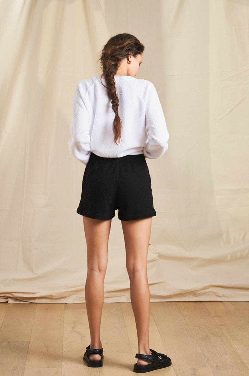 Model wearing the lady & the sailor Weekend Short in Black Boucle.