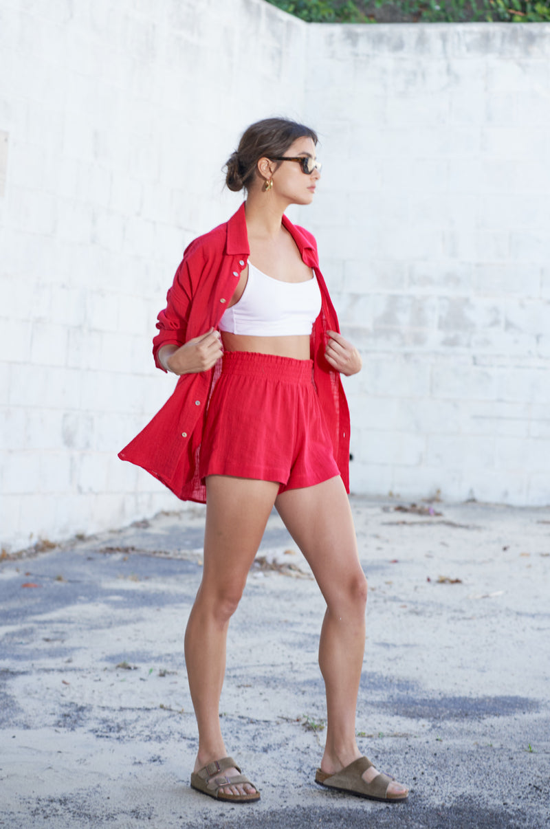 Brunette Model wearing the lady & the sailor Smock Band Shorts in Red Gauze.