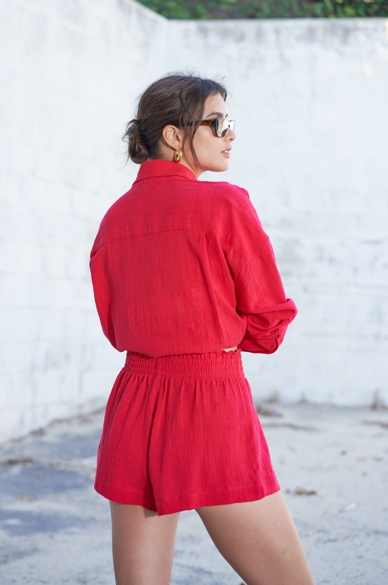 Brunette Model wearing the lady & the sailor Smock Band Shorts in Red Gauze.