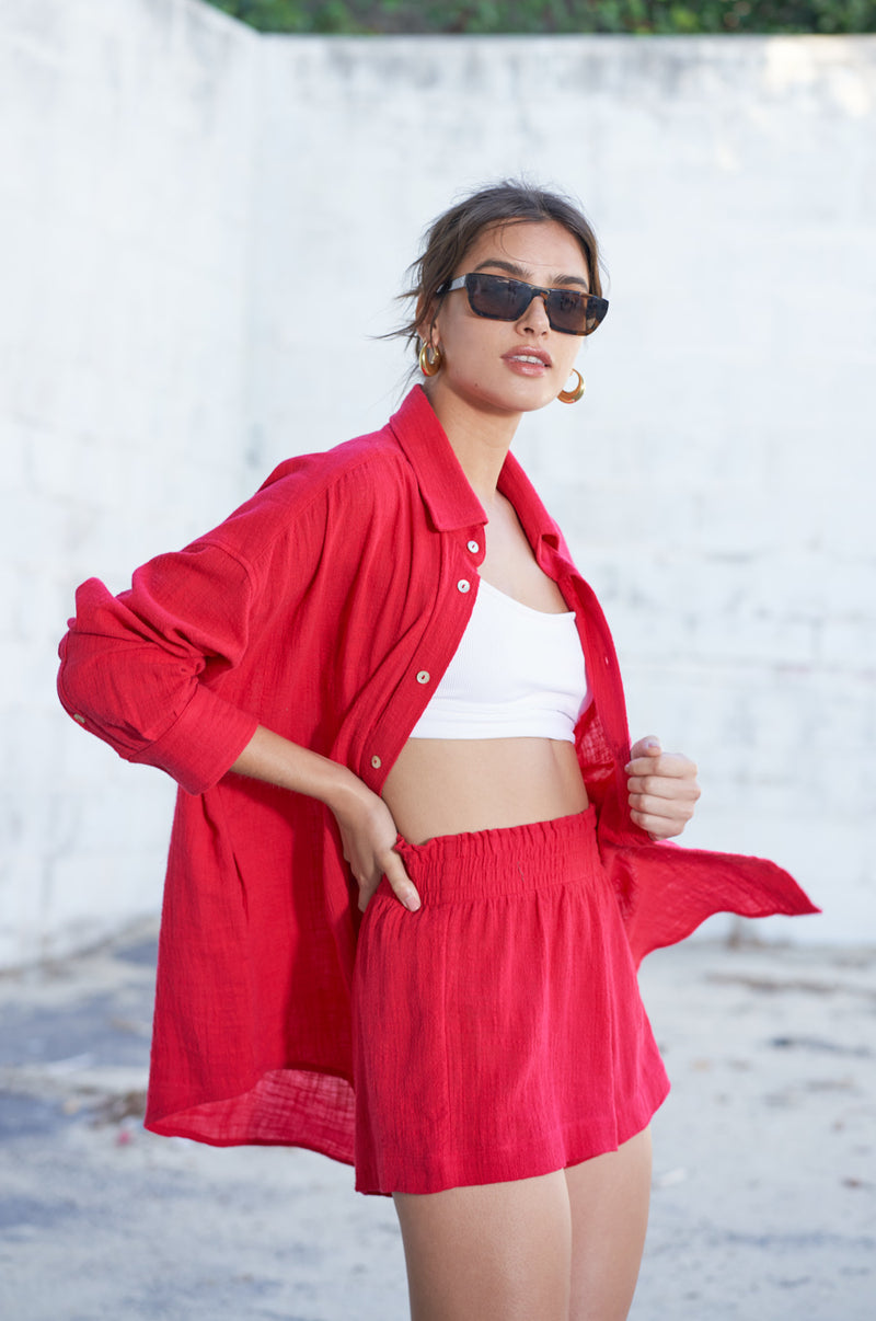 Brunette Model wearing the lady & the sailor Smock Band Shorts in Red Gauze.