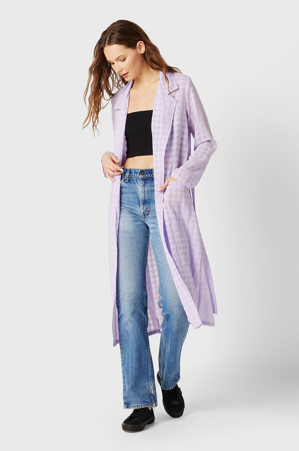 Brunette Model wearing the lady & the sailor Belted Coat in Lilac Gingham.