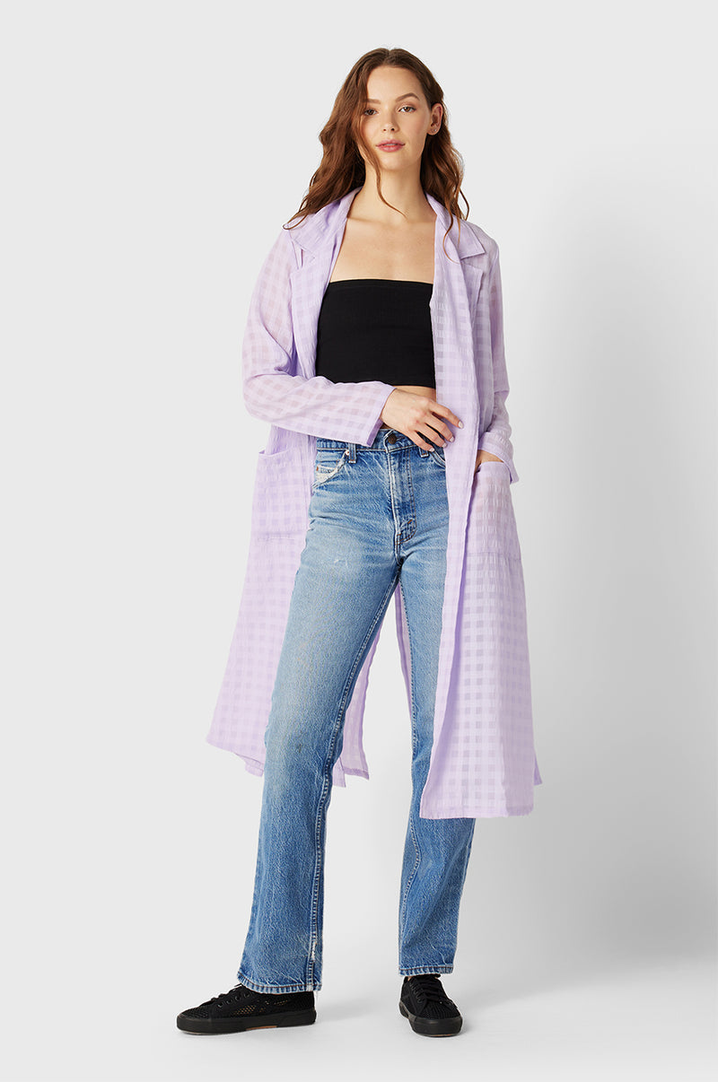 Brunette Model wearing the lady & the sailor Belted Coat in Lilac Gingham.