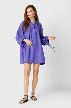 Brunette Model wearing the lady & the sailor Billow Sleeve Mini Dress in Purple.