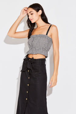 Model wearing the lady & the sailor Cropped Peplum Tank in black gingham.