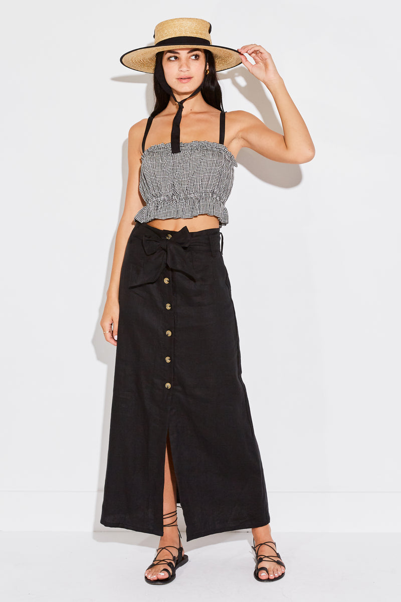 Model wearing the lady & the sailor Cropped Peplum Tank in black gingham.