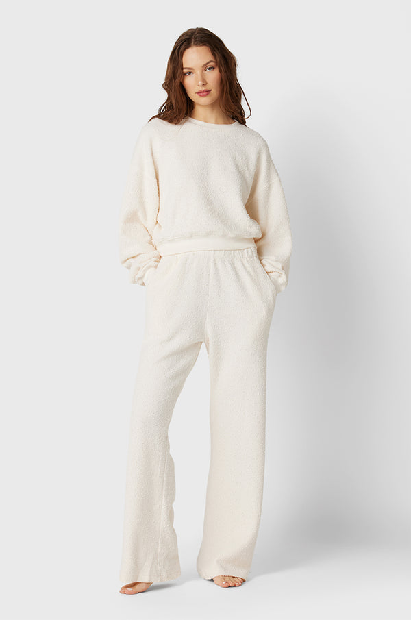 Brunette Model wearing the lady & the sailor Straight Leg Sweatpant in Vanilla Bouclé.