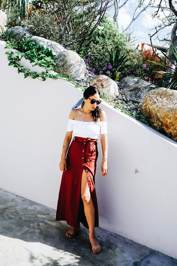 Model wearing the lady & the sailor button front skirt in Scarlett red linen.
