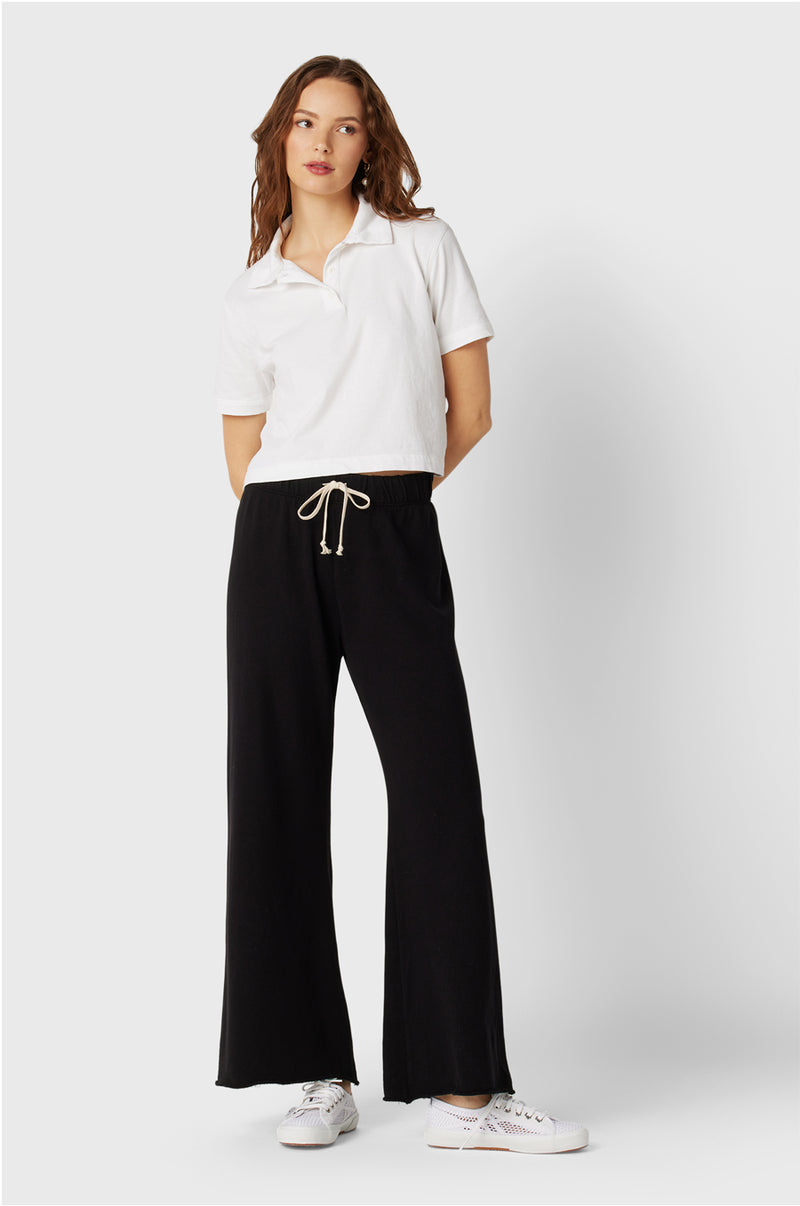 Model wearing the lady & the sailor French Flare Pant in Black Organic Cotton.