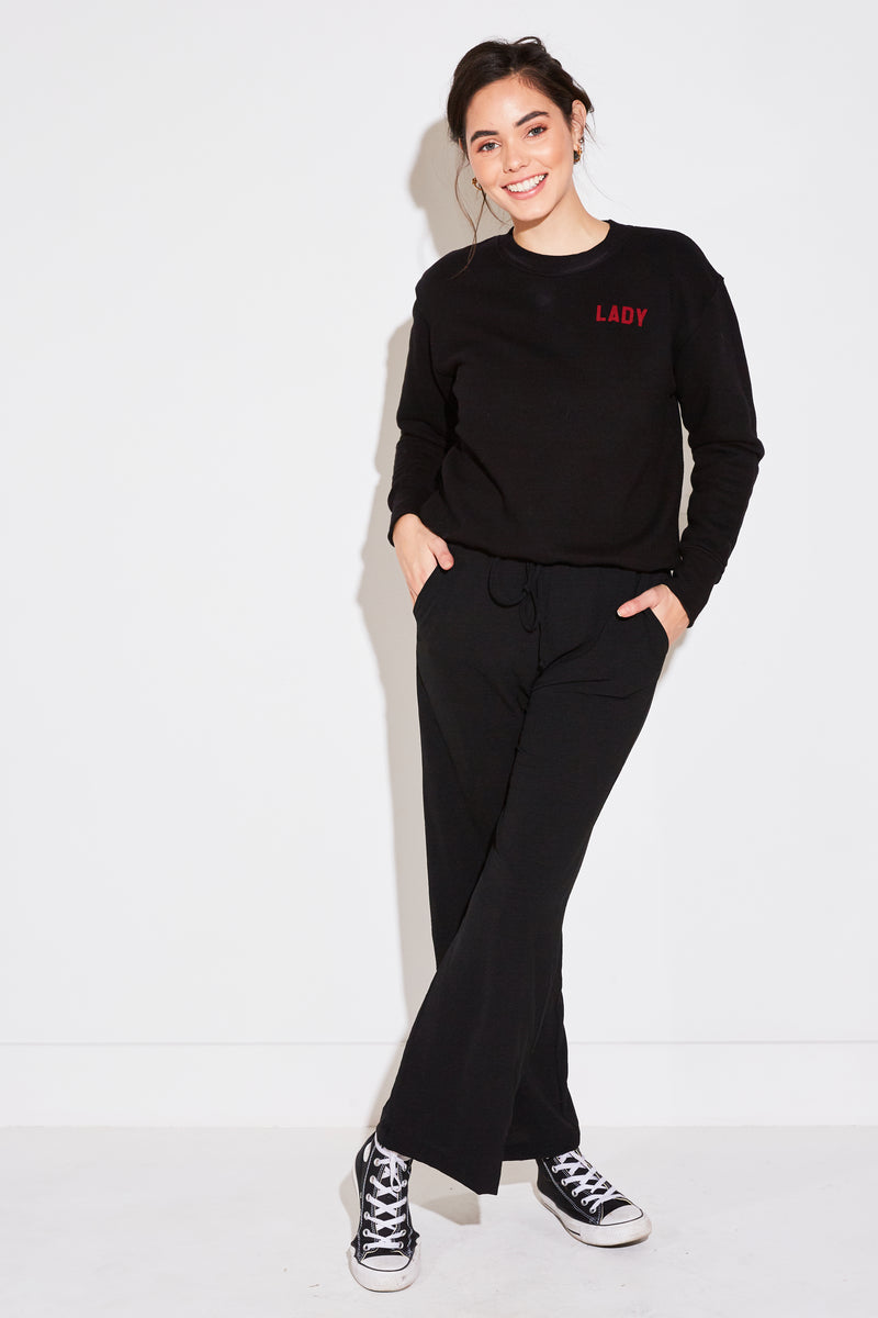 Model wearing the lady & the sailor High Waisted Pant in black air flow.