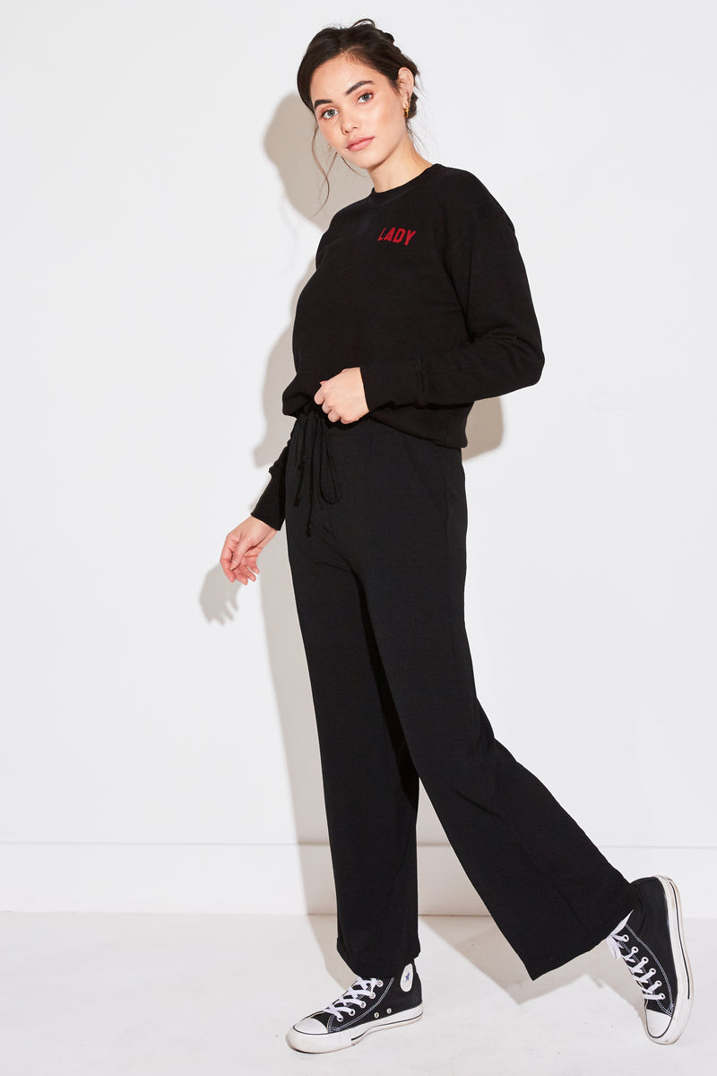 Model wearing the lady & the sailor High Waisted Pant in black air flow.