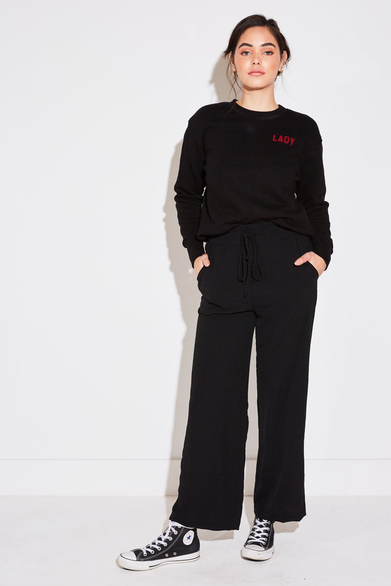Model wearing the lady & the sailor High Waisted Pant in black air flow.