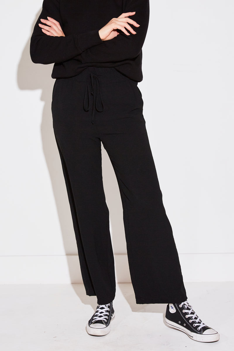 Model wearing the lady & the sailor High Waisted Pant in black air flow.
