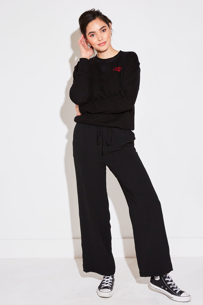 Model wearing the lady & the sailor High Waisted Pant in black air flow.