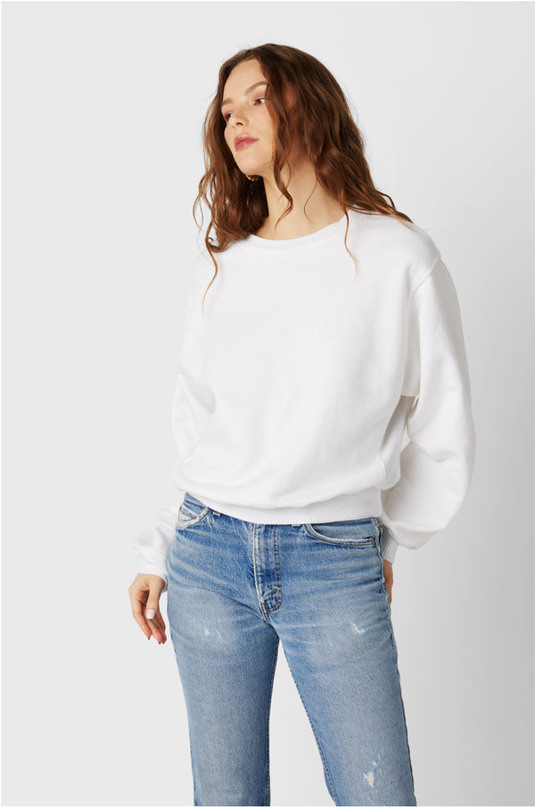 Brunette Model wearing the lady & the sailor The Kristin Sweatshirt in White Fleece.