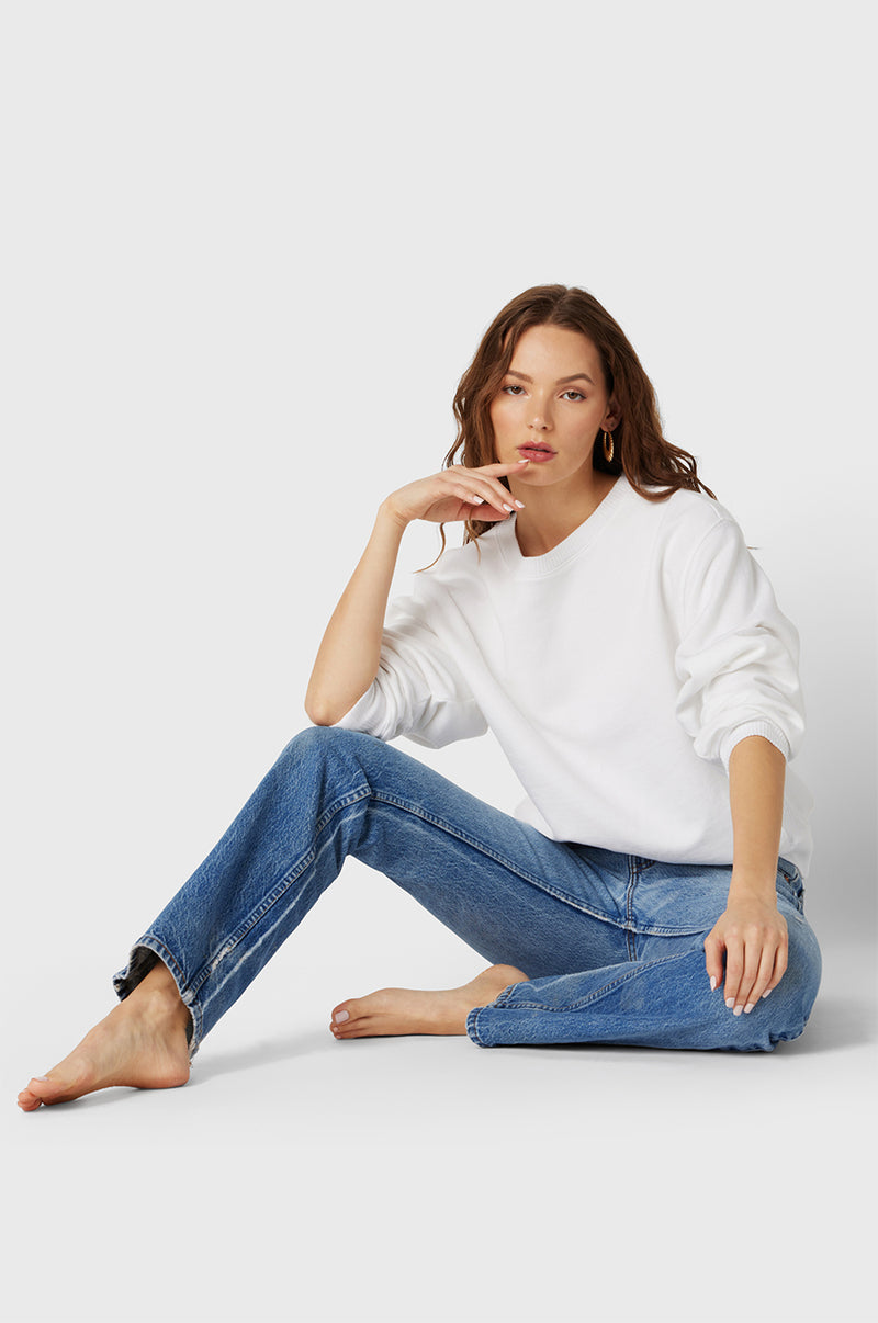 Brunette Model wearing the lady & the sailor The Kristin Sweatshirt in White Fleece.