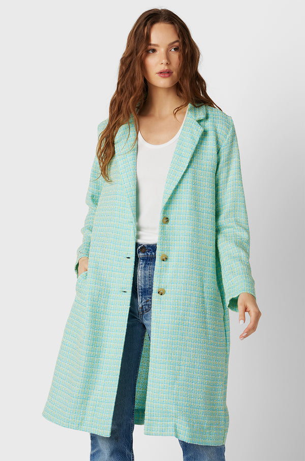 Brunette Model wearing the lady & the sailor Midi Blazer in Aqua Tweed.