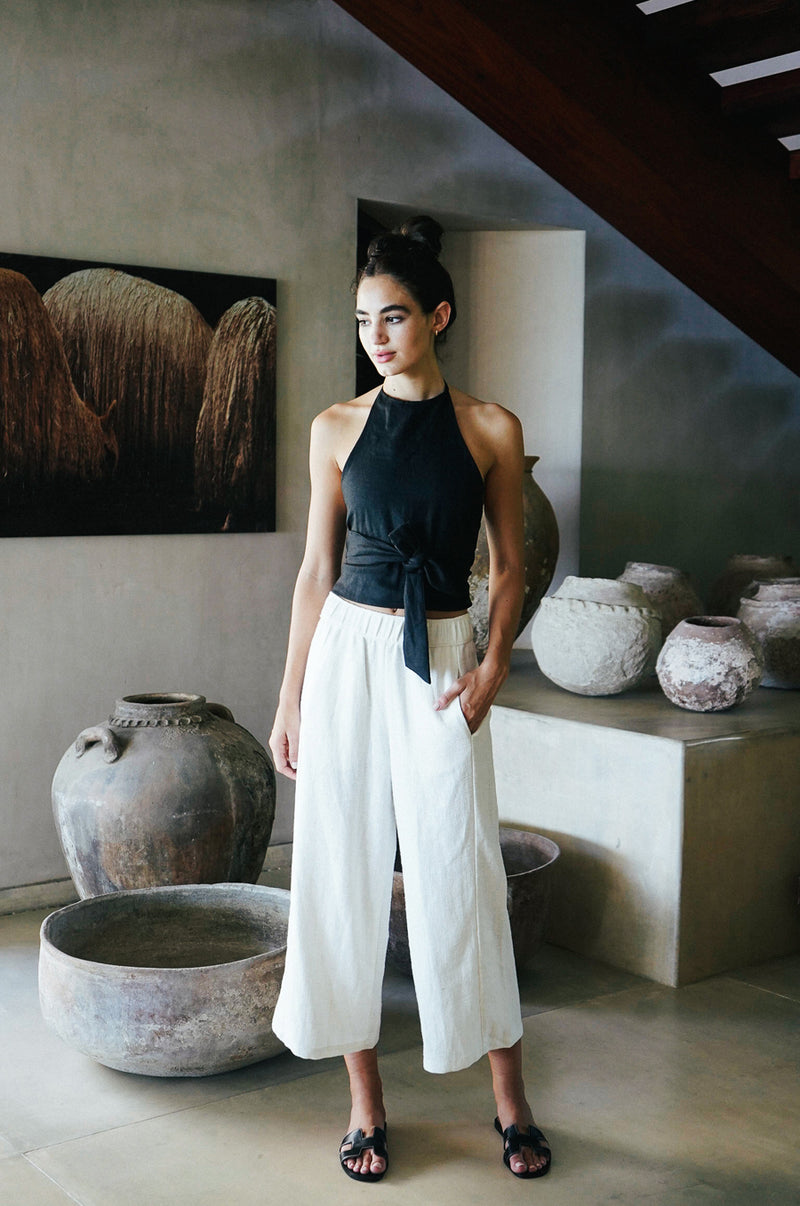 Model wearing the lady & the sailor Wrap Halter Top in black linen.