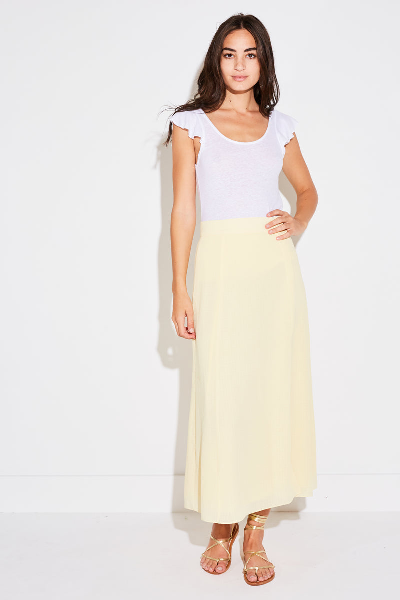 Model wearing the lady & the sailor Panel Skirt in pale yellow french woven.