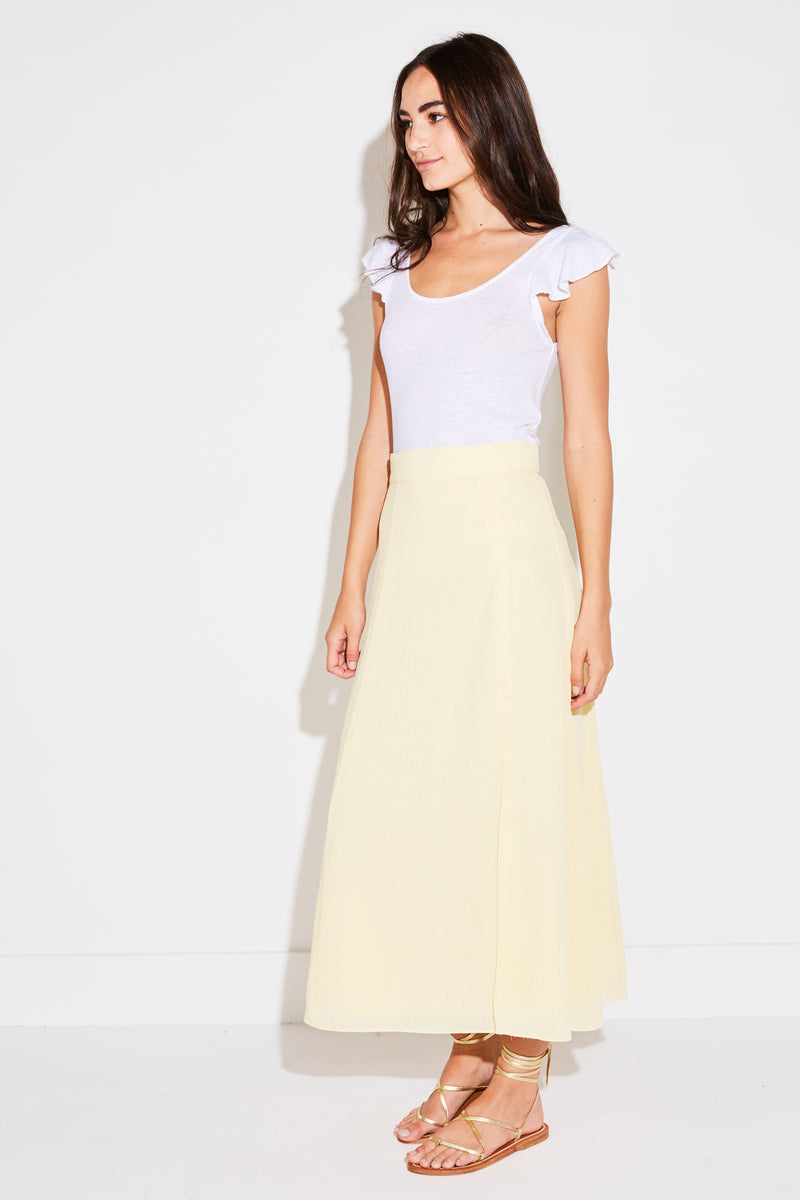 Model wearing the lady & the sailor Panel Skirt in pale yellow french woven.