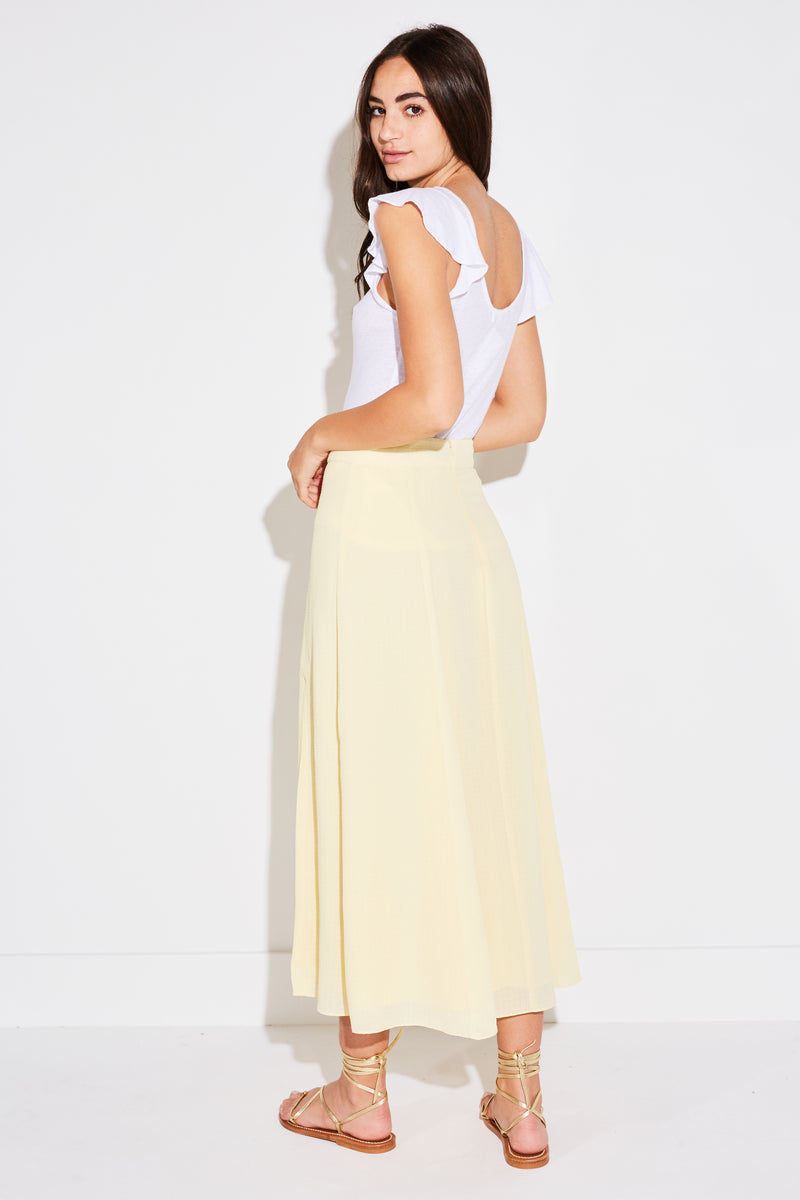 Model wearing the lady & the sailor Panel Skirt in pale yellow french woven.