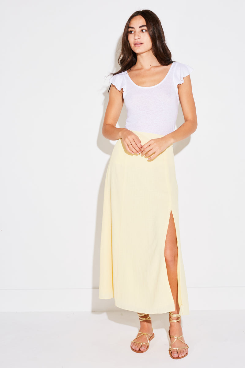 Model wearing the lady & the sailor Panel Skirt in pale yellow french woven.