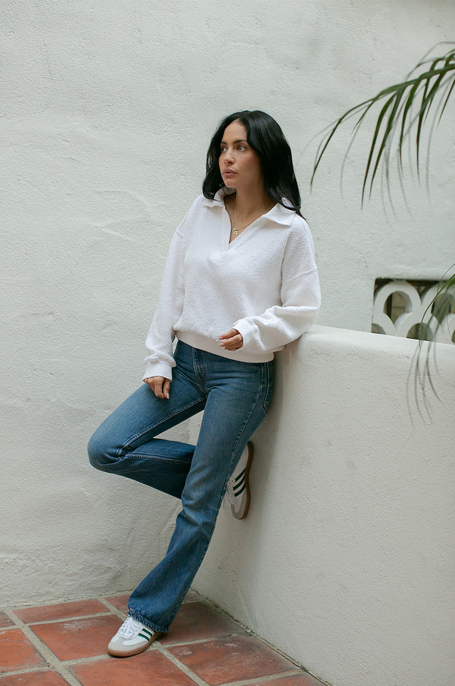 Brunette Model wearing the lady & the sailor Polo Sweatshirt in Vanilla Boulcé.